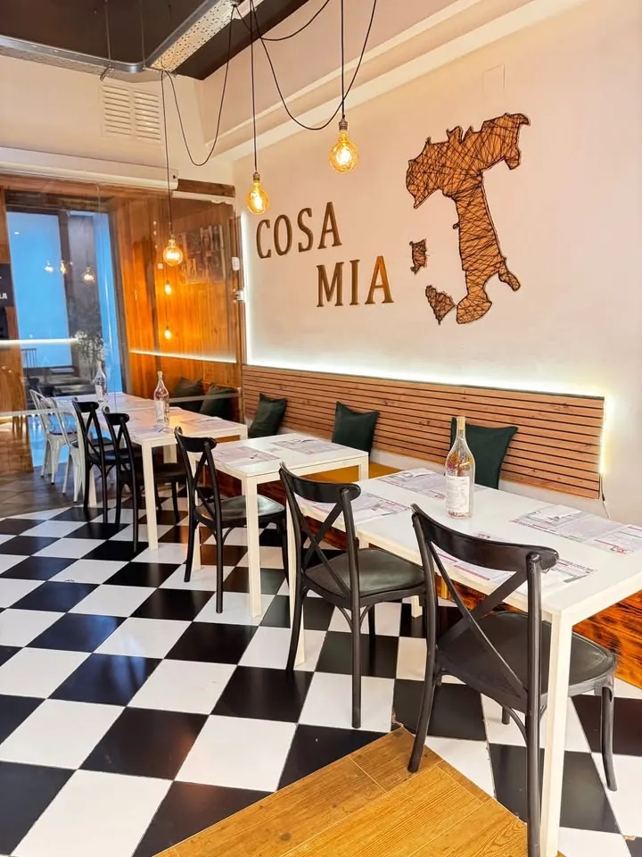 Comedor de Cosa Mia con la pared COSA MIA y el mapa de Italia